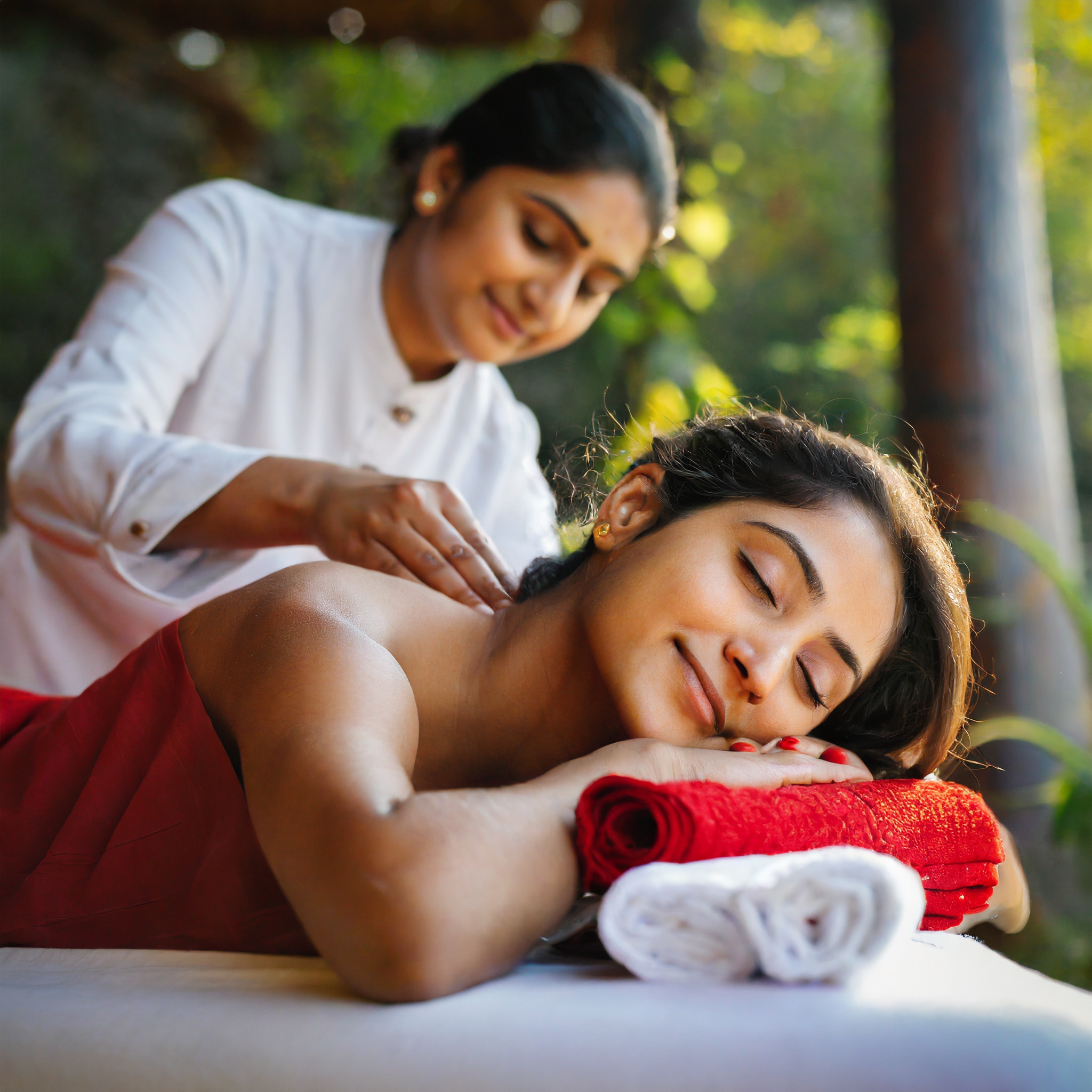 A female masseur givin a neck relaxing Swedish Massage to customer